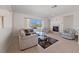 Bright living room with fireplace, tile flooring and natural light from a large window at 2920 Foxtail Creek Ave, Henderson, NV 89052