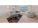 Sunlit living room featuring tile flooring, a comfortable sofa, and a view of the landscape at 2920 Foxtail Creek Ave, Henderson, NV 89052