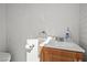 Bathroom with a white sink, wooden vanity, toilet paper holder, and Suave hand soap at 2963 Greendale St, Las Vegas, NV 89121