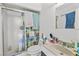 Bathroom with a shower, toilet, and sink with a towel and mirror near a tissue holder at 2963 Greendale St, Las Vegas, NV 89121