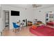 Bedroom with a ceiling fan, desk, TV, and a red bed cover near the closet and bath at 2963 Greendale St, Las Vegas, NV 89121