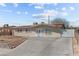 Cozy single-story home featuring a red tile roof, secure window bars, and a spacious concrete driveway at 2963 Greendale St, Las Vegas, NV 89121