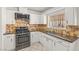Cozy kitchen featuring stainless steel appliances, tile backsplash and white cabinets at 2963 Greendale St, Las Vegas, NV 89121