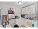 A kitchen features an electric cooktop, white countertops, a microwave, cabinets, and tile floors at 2963 Greendale St, Las Vegas, NV 89121