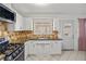 Bright kitchen with stainless steel range, tiled backsplash and white cabinets at 2963 Greendale St, Las Vegas, NV 89121