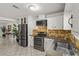 Open kitchen with stainless steel refrigerator and gas range, with white cabinets at 2963 Greendale St, Las Vegas, NV 89121