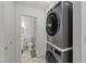 Laundry room with stacked washer and dryer next to a bathroom at 2963 Greendale St, Las Vegas, NV 89121