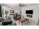 Open living room with tiled floors, ceiling fan, stylish furnishings, and cozy fireplace for a modern ambiance at 2963 Greendale St, Las Vegas, NV 89121
