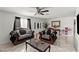 Elegant living room featuring tiled floors, ceiling fan, stylish furnishings and a large window at 2963 Greendale St, Las Vegas, NV 89121