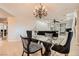 Elegant dining room featuring a modern chandelier, glass-top table, and stylish seating at 3 Chatmoss Rd, Henderson, NV 89052