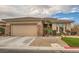 Inviting single-story home with a two car garage, desert landscaping, and stone accents at 3 Chatmoss Rd, Henderson, NV 89052