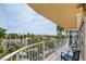 Balcony showcasing seating area and views of palms, community, and distant mountains at 3111 Bel Air Dr # 5F, Las Vegas, NV 89109