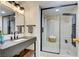 Modern bathroom with a black framed glass shower, floating vanity, and stylish fixtures at 3111 Bel Air Dr # 5F, Las Vegas, NV 89109