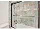 Bathroom showcases a glass shower, marble tile, and chrome fixtures at 3111 Bel Air Dr # 5F, Las Vegas, NV 89109