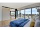 Bedroom with balcony access overlooking palm trees and neighborhood views, sliding door to dining area at 3111 Bel Air Dr # 5F, Las Vegas, NV 89109