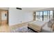 Bedroom features a large balcony, plush rug, and neutral color palette at 3111 Bel Air Dr # 5F, Las Vegas, NV 89109
