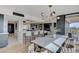 Open-concept living space featuring a stylish dining area with a modern chandelier and kitchen with breakfast bar at 3111 Bel Air Dr # 5F, Las Vegas, NV 89109