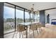 Sunlit dining area with a large window and dining table, offering views of the city skyline and palm trees at 3111 Bel Air Dr # 5F, Las Vegas, NV 89109
