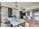 Stylish dining room with a modern chandelier, breakfast bar and sliding door to a balcony with green landscape at 3111 Bel Air Dr # 5F, Las Vegas, NV 89109