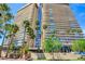 The complex features modern architecture, lush landscaping, and ample parking, all set against a vibrant sky at 3111 Bel Air Dr # 5F, Las Vegas, NV 89109