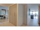 Hallway near an office space, showcasing an elegant closet and a glimpse of the dining and balcony area at 3111 Bel Air Dr # 5F, Las Vegas, NV 89109