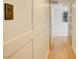 Bright hallway features custom-paneled walls, hardwood flooring, and recessed lighting at 3111 Bel Air Dr # 5F, Las Vegas, NV 89109