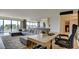 Bright living room featuring a modern sectional sofa, adjacent kitchen, and views to the balcony at 3111 Bel Air Dr # 5F, Las Vegas, NV 89109