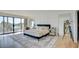 Bright main bedroom offers a balcony, stylish furniture, and hardwood floors at 3111 Bel Air Dr # 5F, Las Vegas, NV 89109