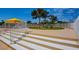 This outdoor space has lounge chairs under a yellow awning with a neatly manicured lawn and white fence at 3111 Bel Air Dr # 5F, Las Vegas, NV 89109