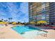 Relax by the community pool with comfortable lounge chairs and shady cabanas, next to high rise building at 3111 Bel Air Dr # 5F, Las Vegas, NV 89109
