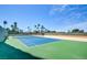 Enjoy a match on this well-maintained tennis court, surrounded by lush trees and a clear blue sky at 3111 Bel Air Dr # 5F, Las Vegas, NV 89109