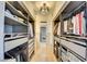 Walk-in closet with custom shelving, and ample storage for clothes and accessories at 3111 Bel Air Dr # 5F, Las Vegas, NV 89109