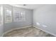 A sunlit bedroom features wood-look floors, plantation shutters, and fresh neutral walls, offering a serene retreat at 3197 Castle Canyon Ave, Henderson, NV 89052