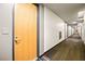 Hallway leading to apartment homes, featuring neutral walls and patterned carpeting at 353 E Bonneville Ave # 311, Las Vegas, NV 89101