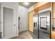 Hallway with closet and entry doors near a stainless steel refrigerator providing convenient access and storage at 353 E Bonneville Ave # 311, Las Vegas, NV 89101