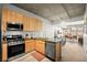 Stylish open concept kitchen with stainless appliances, granite counters, and wood cabinets at 353 E Bonneville Ave # 311, Las Vegas, NV 89101