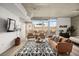 Open-concept living area with comfortable seating, large windows, and a partial view of the bedroom at 353 E Bonneville Ave # 311, Las Vegas, NV 89101