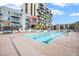 Outdoor pool area with lounge chairs, lush landscaping, and community amenities at 353 E Bonneville Ave # 311, Las Vegas, NV 89101