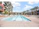 Large community pool featuring lounge chairs and modern architecture at 353 E Bonneville Ave # 311, Las Vegas, NV 89101