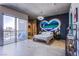 Bright bedroom with a painted heart on the wall, modern lighting, and large windows with city views at 353 E Bonneville Ave # 905, Las Vegas, NV 89101