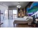 Modern bedroom featuring graffiti heart art wall, minimalist light fixture, and a private balcony at 353 E Bonneville Ave # 905, Las Vegas, NV 89101