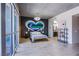 Spacious bedroom boasts a painted heart on the wall, contemporary lighting, and an en-suite bathroom at 353 E Bonneville Ave # 905, Las Vegas, NV 89101