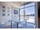 Modern dining area with floor-to-ceiling windows offering city views and seating for four at 353 E Bonneville Ave # 905, Las Vegas, NV 89101