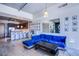 Open-concept living room with a blue velvet sofa, breakfast bar, and hardwood floors at 353 E Bonneville Ave # 905, Las Vegas, NV 89101