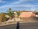 Charming single-story home featuring a two-car garage and desert landscaping with palm trees and rock accents at 441 Daylin Ct, Henderson, NV 89015
