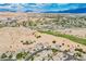 Expansive aerial view of a desert community with golf course, mountains, and houses with pools at 479 Apogee, Mesquite, NV 89027