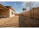 Large backyard featuring gravel surface, brick patio, and block wall surround at 479 Apogee, Mesquite, NV 89027