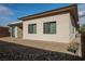 Back of house featuring gravel surface, brick patio, and desert landscaping at 479 Apogee, Mesquite, NV 89027