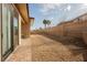 Large backyard featuring gravel surface, brick patio, and block wall surround at 479 Apogee, Mesquite, NV 89027