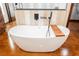 Bright main bathroom features a soaking tub and dark modern fixtures at 479 Apogee, Mesquite, NV 89027